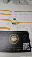 Ring set on certificate and warranty card showing authenticity and grading details.