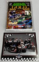 Front cover of MBNA Gold 200 magazine featuring two race cars and racing event logos