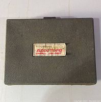 Closed black plastic carrying case with AccuTorq label on lid