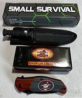 Both knives displayed with packaging: survival knife in sheath, locking folder and box labeled 'Garage Knife Collection'