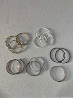 Top view showing 12 assorted bracelets grouped by style and color on a flat surface.