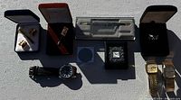 Overview of all items including watches, cufflinks, ring, pendant necklace, and pens.