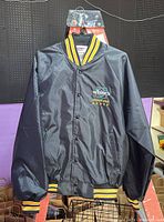 Full front view of new Whites Authorized Dealer jacket, black with striped ribbing