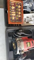 King Canada router with case and wood bit case seen inside plastic carrying case.