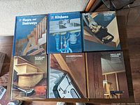 Top view of the first 5 books: Floors and Stairways (two copies), Kitchens, Weatherproofing, Walls and Ceilings.