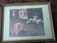 Full view of the framed art print showing a Native American man sitting while sheep graze in a wooded field.
