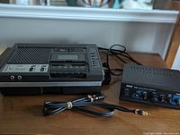 Photo showing the Sharp RD-671AV cassette recorder/player on left and Pyle PTA2 stereo power amplifier on right, with cables in front.