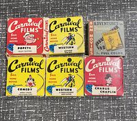 Top view of six Carnival Films 8mm home movie films and one Adventures in Disneyland 8mm film showing front box cover art and titles