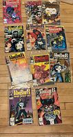 Top-down view of 11 vintage comic books featuring The Punisher in various action poses and backgrounds.
