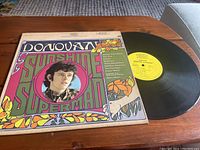 Front view of Donovan Sunshine Superman vinyl record with colorful cover and record partially out of sleeve.