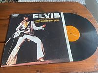 Front cover of Elvis Presley vinyl LP record 'As Recorded At Madison Square Garden' shows Elvis in white jumpsuit performing on stage with guitar.