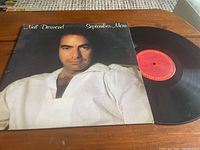 Front cover of the vinyl album featuring Neil Diamond and the red center label of the vinyl record.