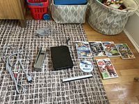 Full lot items including console, power adapter, sensor bar, AV cables, 6 game discs with cases, remote controller.