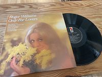 Front cover of the album sleeve showing a woman holding yellow flowers, with the album title and artist name.