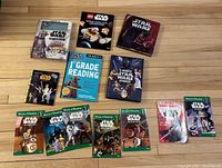 Photo showing 11 Star Wars themed books arranged on floor including The Mandalorian, LEGO Star Wars guides, and World of Reading books for children.