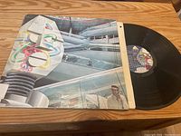 Front album cover for The Alan Parsons Project 'Robot' showing futuristic industrial artwork and the vinyl record partially out of the cover.