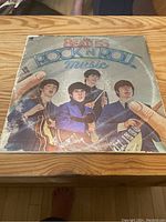 Front cover of The Beatles vinyl record album 'Rock N Roll Music' showing illustrated band members and title.