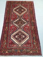 Full view of the rug laid flat showing triple medallion and border pattern