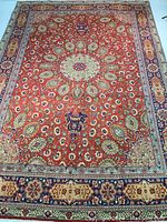 Full view of red field and navy blue border with floral motifs on white background