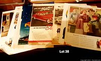 Image showing a stack of 8 original advertisements from 1948, partially fanned out, featuring various brands and designs, some showing cars and people.