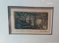 Close-up photo of the framed artwork showing the title "Blue Wheel," signature, and limited edition number 7/10 by M. Swartz.