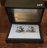 Close-up photo of silver-tone golfer cufflinks in original box, showing detail of golf bag and clubs design.