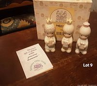 Three Precious Moments 'We Three Kings' figurines in front of original box along with booklet