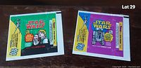 Two vintage Star Wars bubble gum wrappers, one green with characters and one purple with R2-D2.