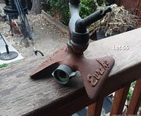 Side view of vintage Eureka sprinkler showing triangular base and rotary arm