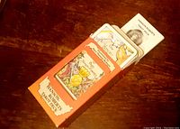 Image showing Hanson Roberts Tarot deck partially in original orange box with artwork and labeling visible.