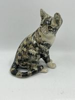 Front-side view of the ceramic cat figurine showing detailed painting and posture.