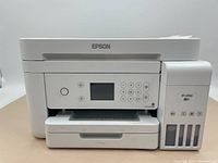 Front view of Epson ET-3760 multifunction printer with control panel, buttons, and visible ink tanks.