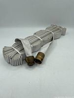 Coiled large diameter water hose with brass connectors on each end, shown on a plain white background for condition and detail inspection.