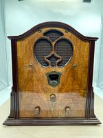 Front view of radio showing wooden case, speaker grill and control knobs