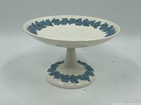 Side view of the Wedgwood compote dish showing the shape, pedestal base, and grapevine relief decoration.