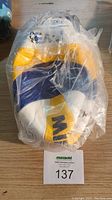 MIKASA VLS300 Beach Champ volleyball sealed in original clear plastic packaging with visible yellow and blue panels and logo.
