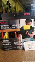 Box front and partial side view showing SPRI Xertube Combo Kit packaging with professional durability resistance tubes in yellow, red and black.