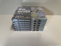 Stack of six sealed boxes of Kuelox Soft Oil Pastels, each containing 24 colors, visible from the side.