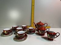 Full set with 6 cups, 6 saucers, teapot, sugar bowl, and creamer displayed on white background with measuring tape.