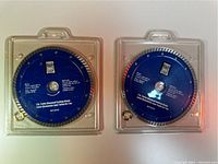 Two Power Fist diamond cutting blades in clear plastic cases, one 7 1/4 inch and one 7 inch turbo blades.