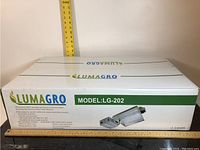 Box front showing Lumagro branding, model LG-202, and product illustration.