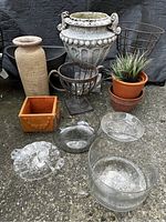 Group shot showing the assortment of planters, vases, metal plant stands, glass bowls, and a faux plant.