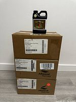 Three sealed cardboard cases of Advanced Nutrients Sensi Coco Grow Part A fertilizer stacked with one jug on top, all with original labels and packaging tape intact.