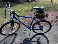 Full side view of the blue Giant Sedona RST all terrain bike parked on pavement outdoors in daylight, showing overall design and condition.