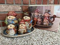 Snowmen kitchen set displayed on carpet with original box behind showing similar figures