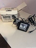 Sunpak Video Light 3000 unit shown with power cord and original box on a white surface.