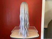 Front and sides view of the 31 inch lace front lavender straight synthetic wig displayed on a wig stand against a red background.