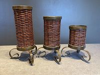 Front view of the three wicker and metal pillar candle holders in descending height order