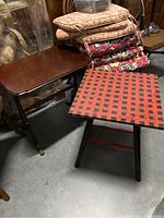 Both side tables together with some cushions stacked on one