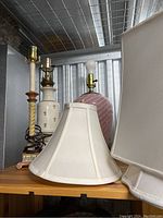 Three table lamps clustered together showing different bases and shades.